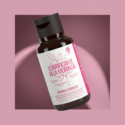 Lubrifiant intime naturel au Moringa RedMoringa avec huile d'amande et rose musquée, flacon sur fond rose